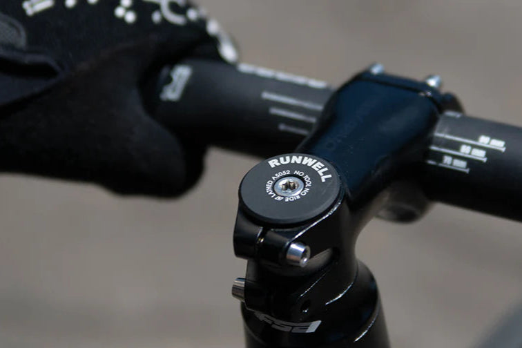 Close-up photo of the Runwell RW TOP CAP made of aluminum anodized black installed on a fixed gear fixie stem headset