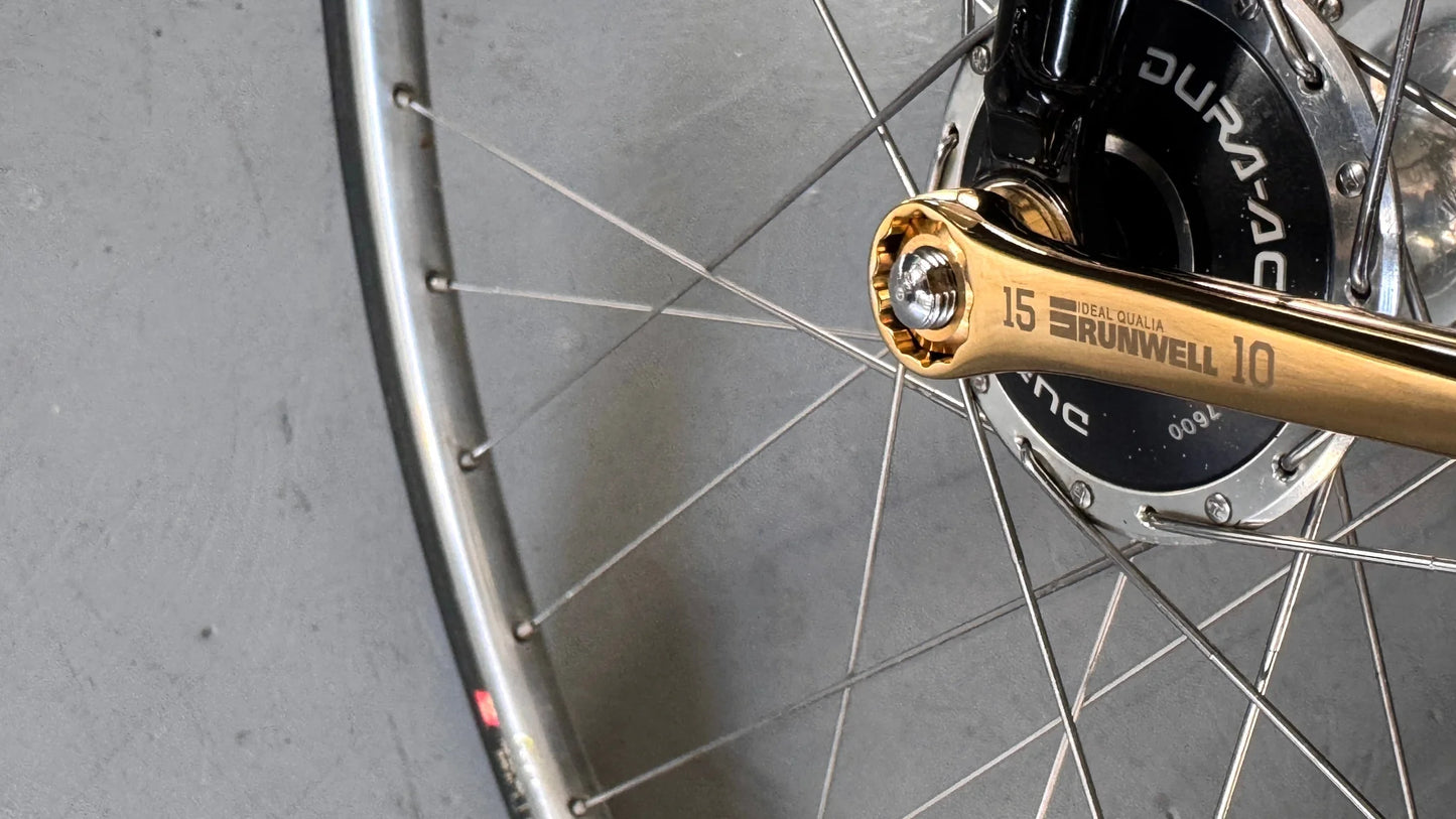 Titanium coated Gold bicycle tool by Runwell Japan, Nezile1510 15mm 10mm action shot on a track bike wheel nut